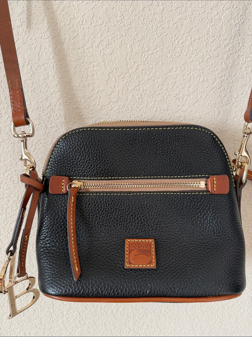Dooney and Bourke Pebble Grain Leather Domed Crossbody Navy and Tan